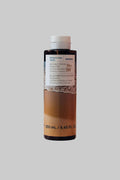 Bottle of Korres sea salt cocoon shower gel on a white background